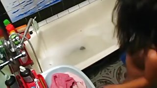 Voyeur tapes a hot girl playing with herself in the bathtub